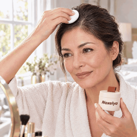 Woman patting root touch-up powder along her hairline